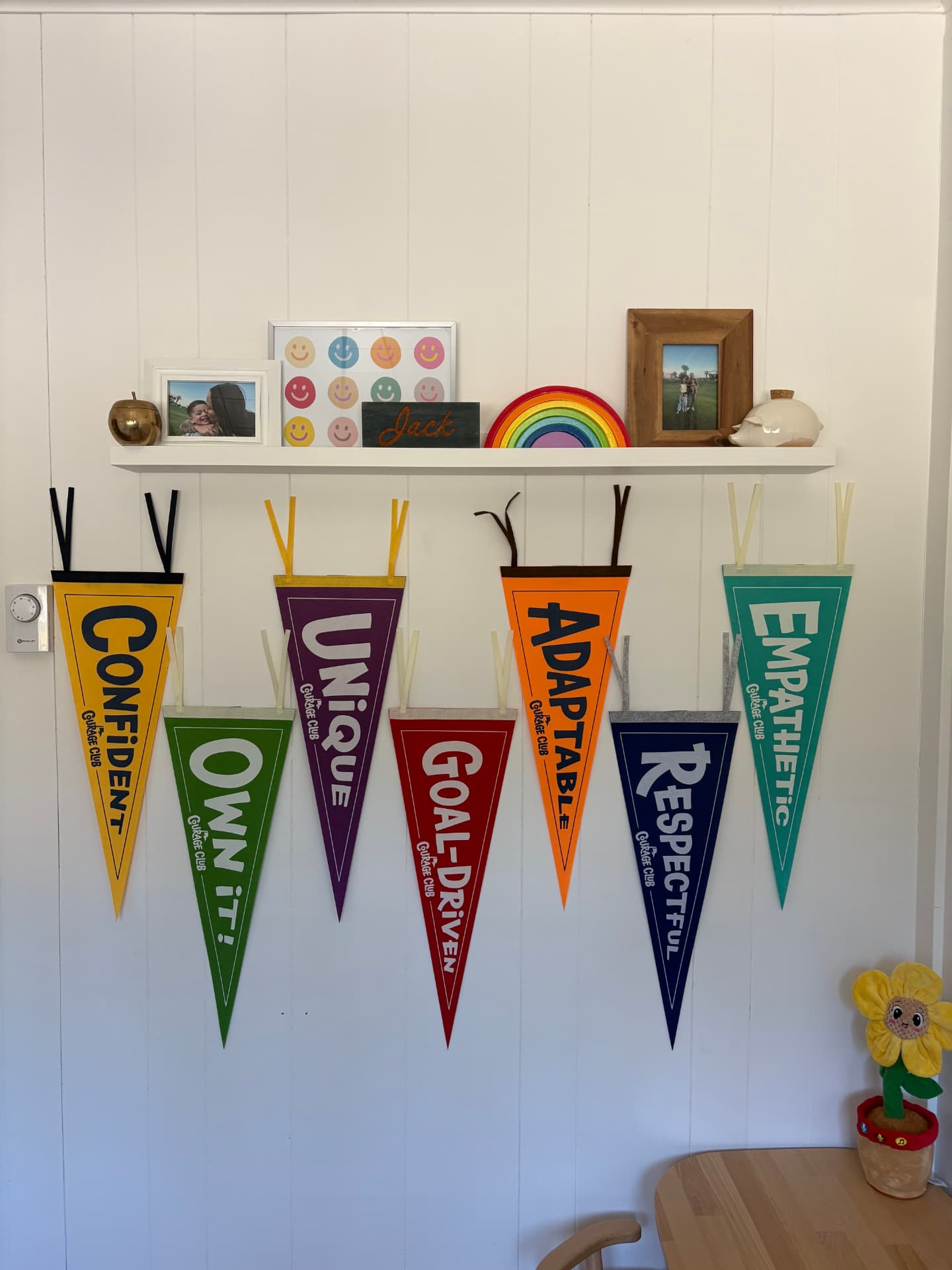 All seven COURAGE pennants hanging on a wall